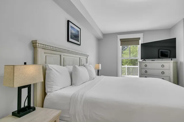 a bedroom with a bed and a painting on the wall