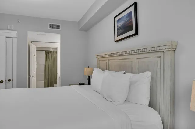a bathroom with a double vanity sink toilet mirror and shower