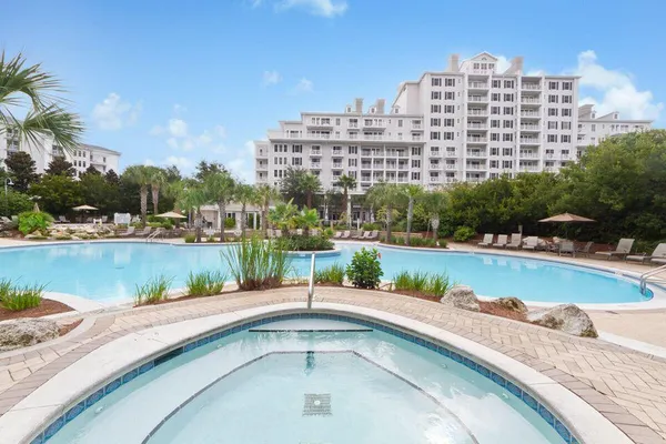 a view of swimming pool with outdoor seating and plants