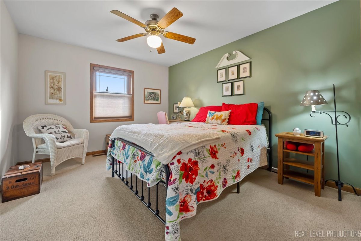 4381 North St Route Leland, IL 60531 - Photo 11 of 36 a bedroom with a bed and a chandelier