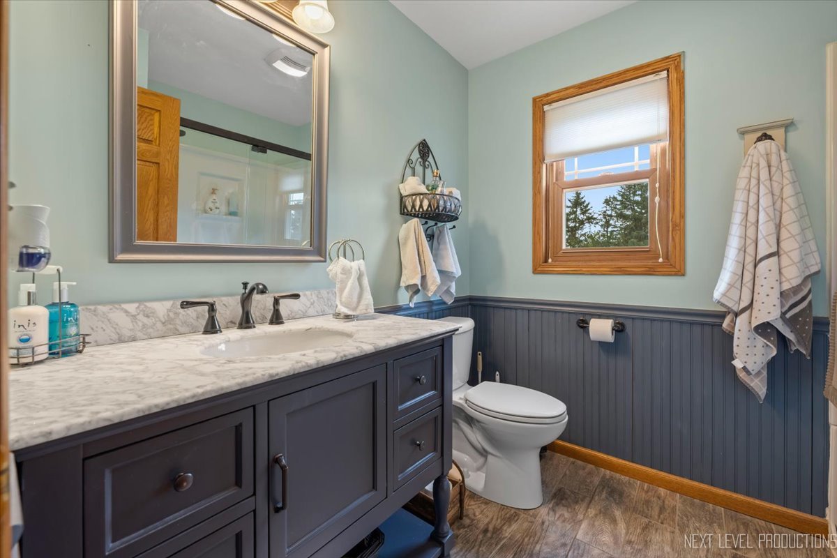 4381 North St Route Leland, IL 60531 - Photo 12 of 36 a bathroom with a granite countertop sink and a toilet