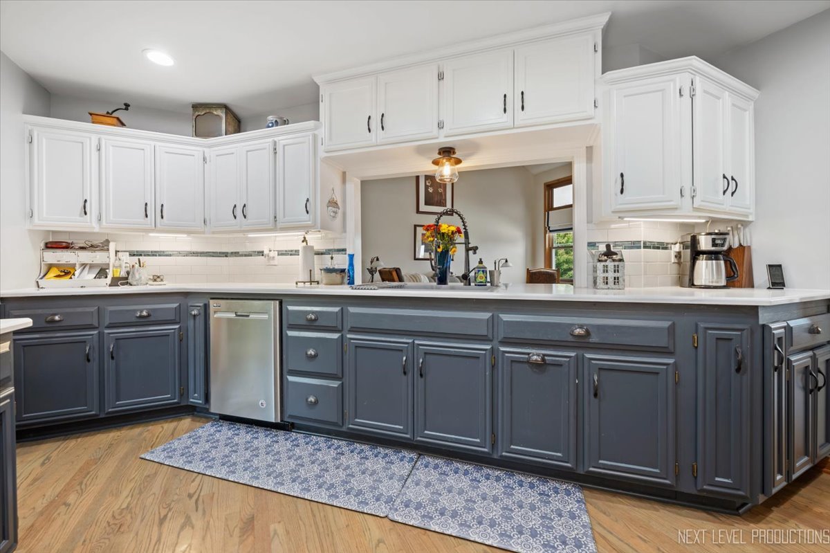4381 North St Route Leland, IL 60531 - Photo 16 of 36 a kitchen with kitchen island granite countertop a sink cabinets and stainless steel appliances