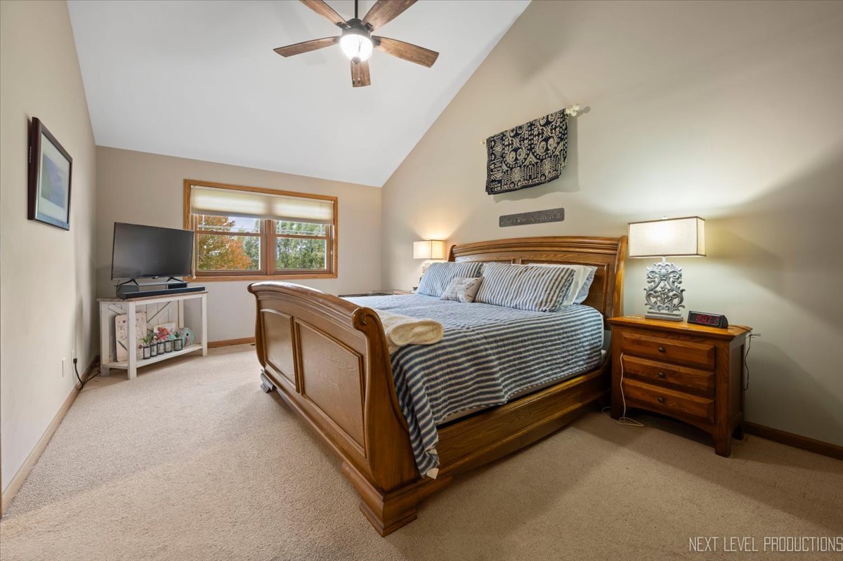 4381 North St Route Leland, IL 60531 - Photo 22 of 36 a spacious bedroom with a bed and a flat screen tv