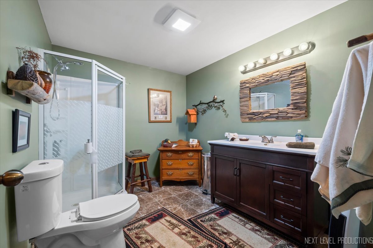 4381 North St Route Leland, IL 60531 - Photo 29 of 36 a bathroom with a toilet a sink and mirror