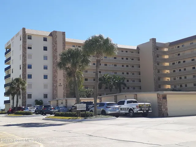 a car parked in front of a tall building