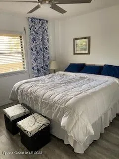 a bedroom with a bed and a refrigerator