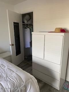 1830 North Atlantic Avenue, Unit 205 Cocoa Beach, FL 32931 - Photo 12 of 28 a bedroom with a bed and a refrigerator