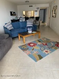 a living room with furniture and a dining table