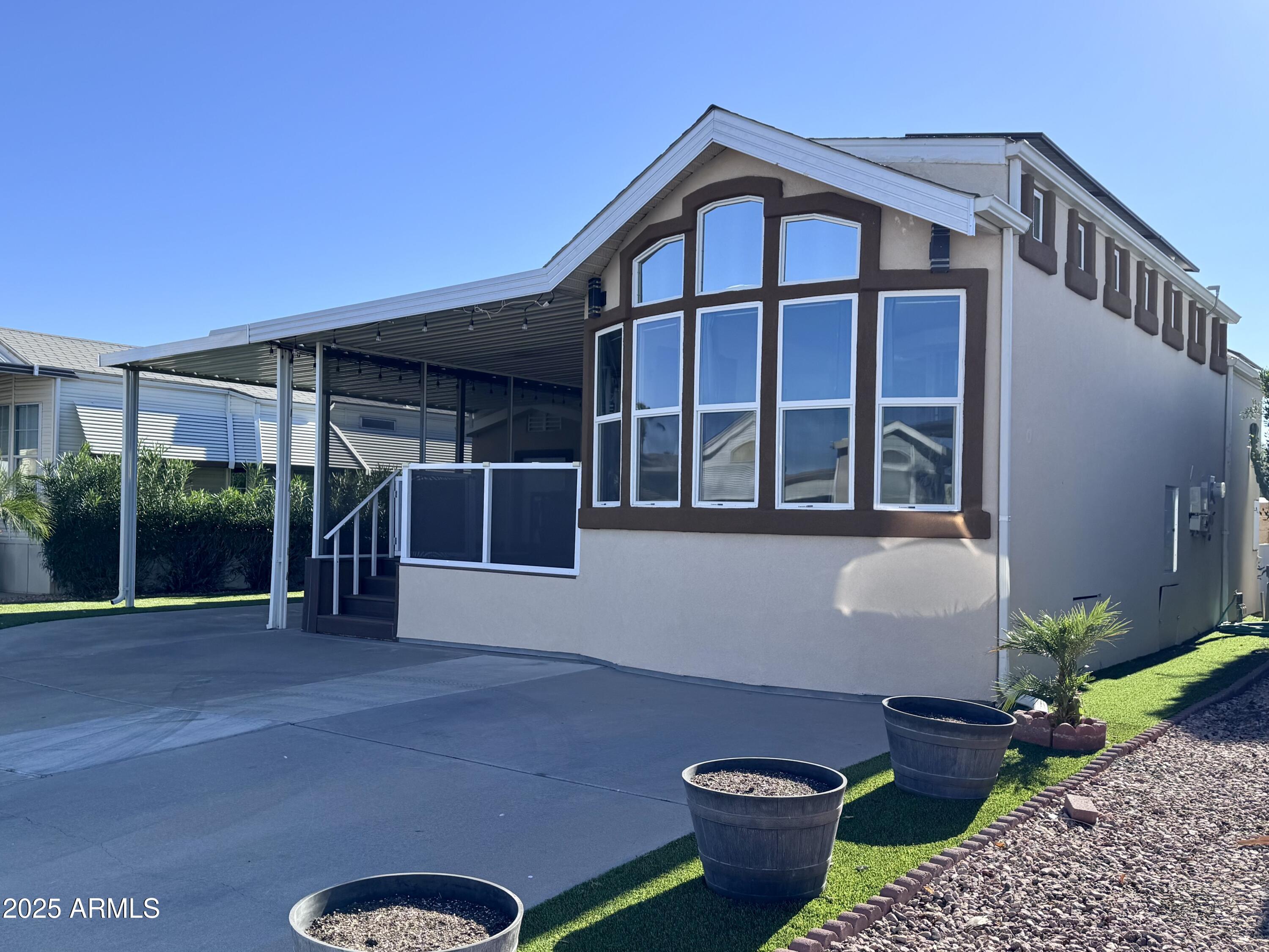 17200 West Bell Road, Unit 454 Surprise, AZ 85374 - Photo 1 of 24 a front view of a house with a yard