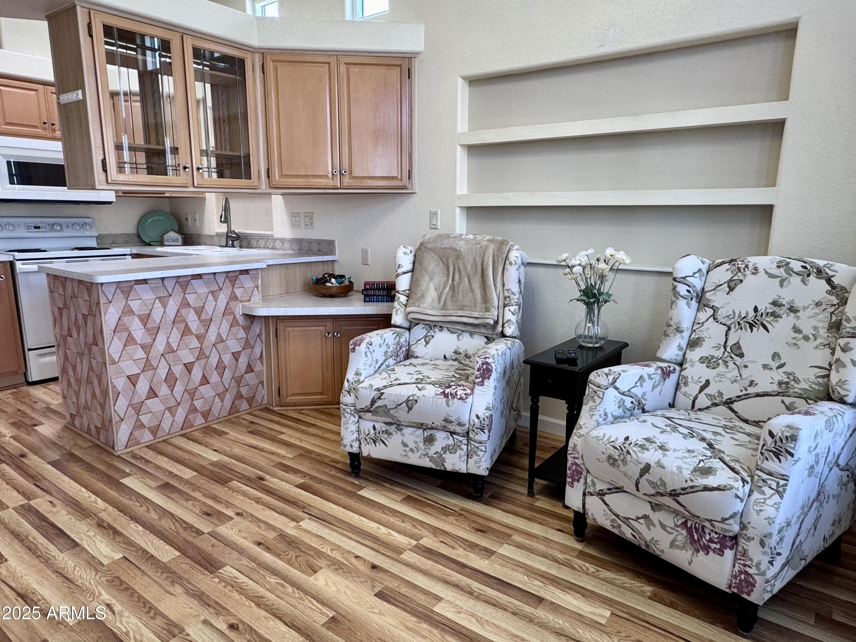 17200 West Bell Road, Unit 454 Surprise, AZ 85374 - Photo 3 of 24 a kitchen with furniture and a wooden floor