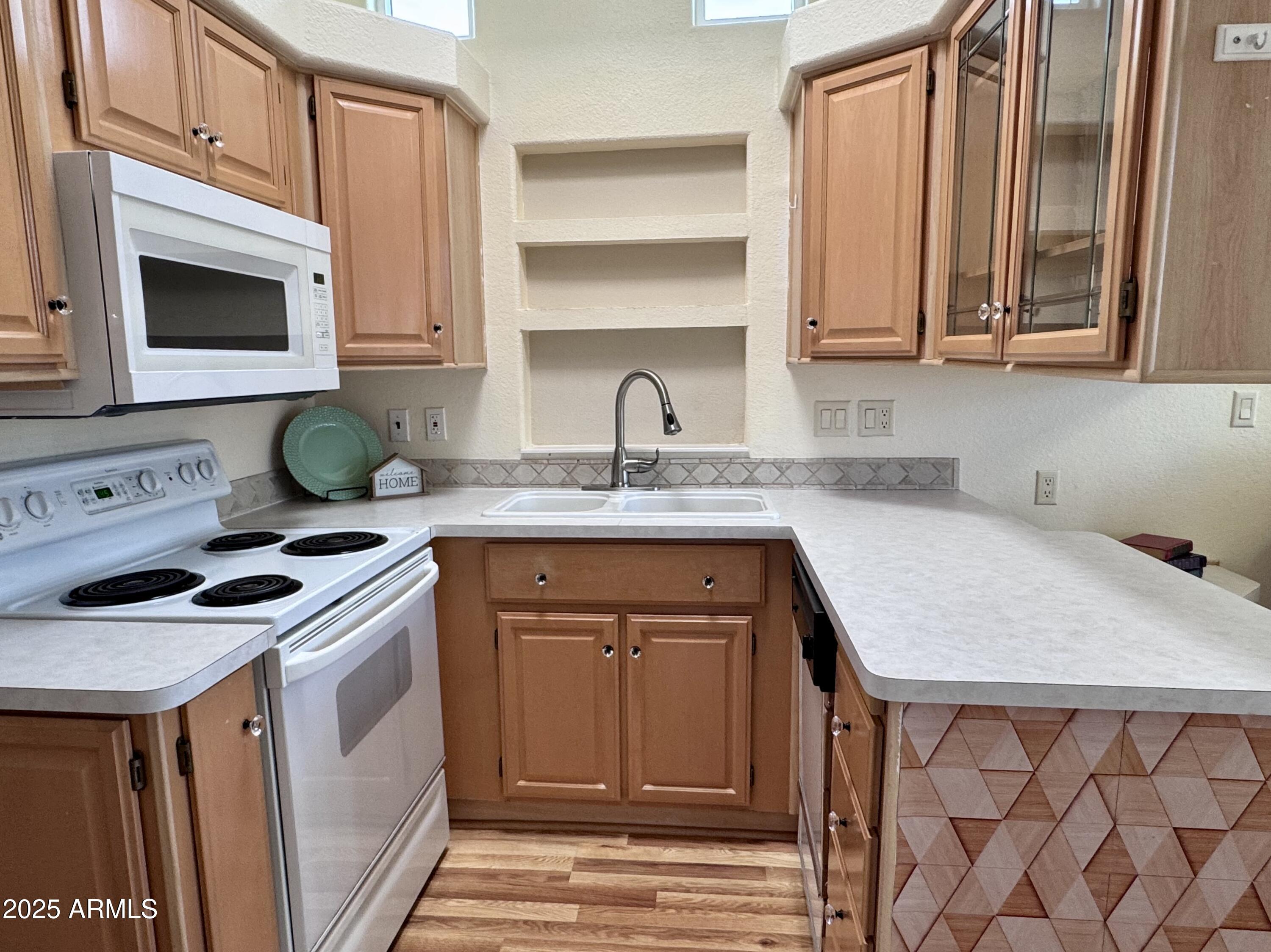 17200 West Bell Road, Unit 454 Surprise, AZ 85374 - Photo 5 of 24 a kitchen with stainless steel appliances granite countertop a stove a sink and a microwave