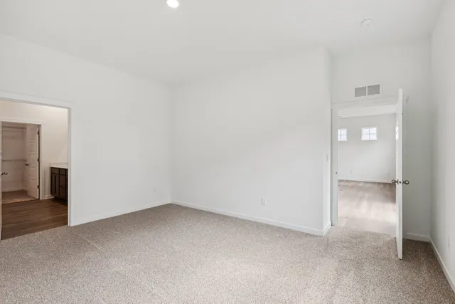 an empty room with an entrance to other room
