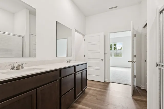 a bathroom with a double vanity sink and mirror