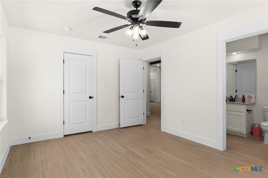 3025 Millhouse Road Copperas Cove, TX 76522 - Photo 29 of 38 a view of a livingroom with a ceiling fan and a kitchen
