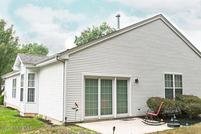 a view of a house with a yard and sitting area
