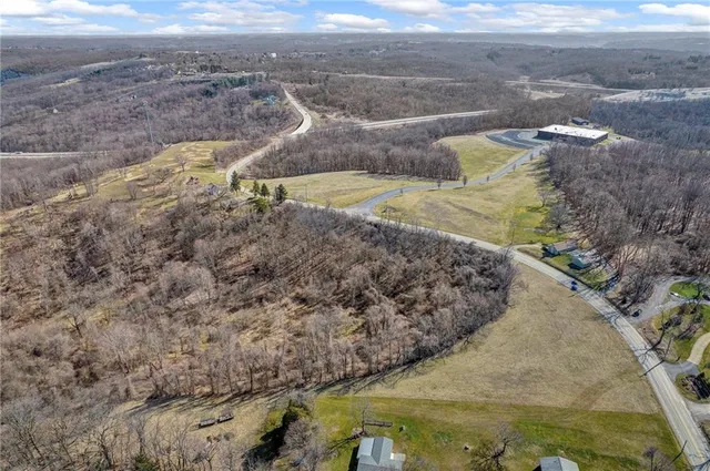 a view of a dry yard with wooden fence