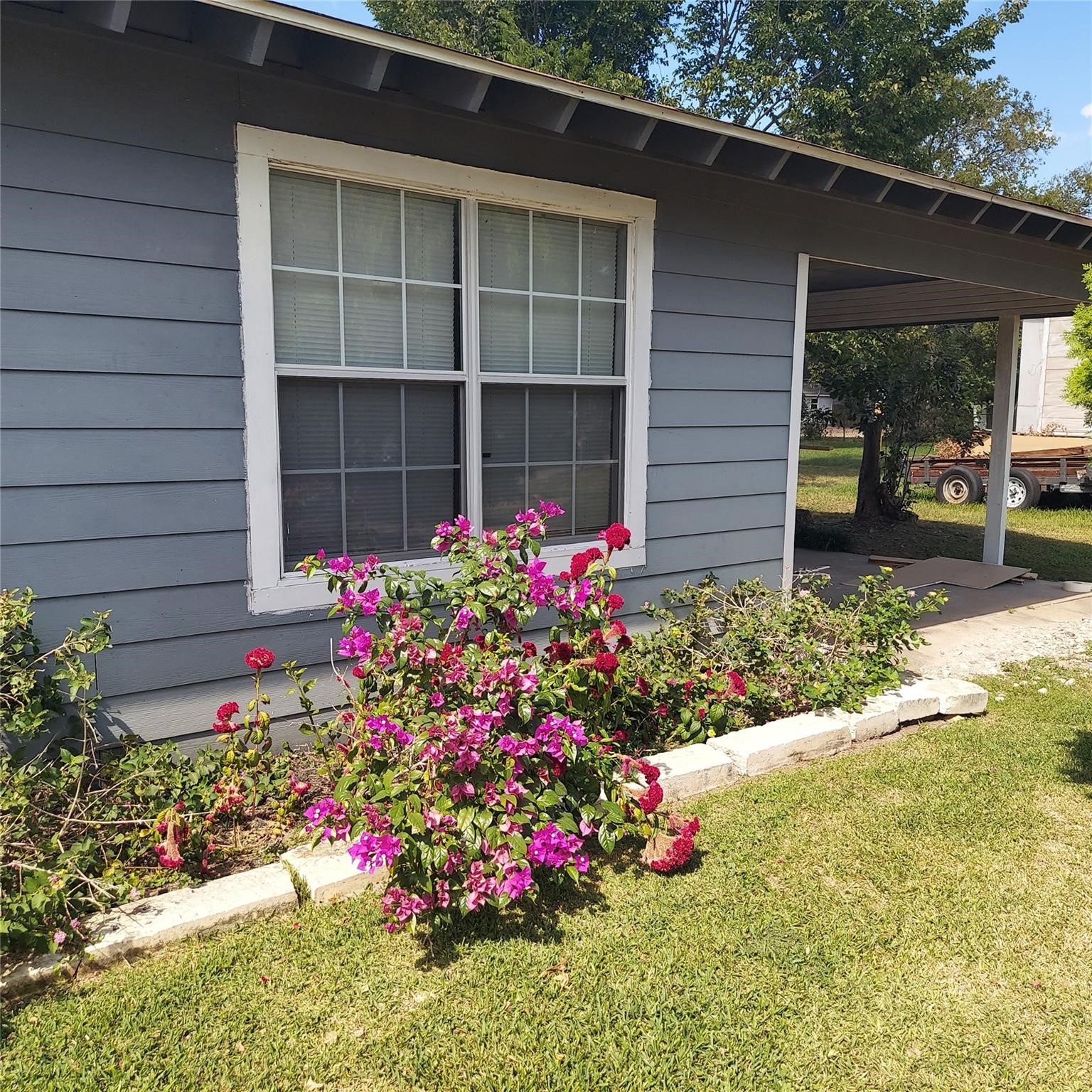 1025 6th Street Hempstead, TX 77445 - Photo 11 of 11 a view of a flower garden in front of a house