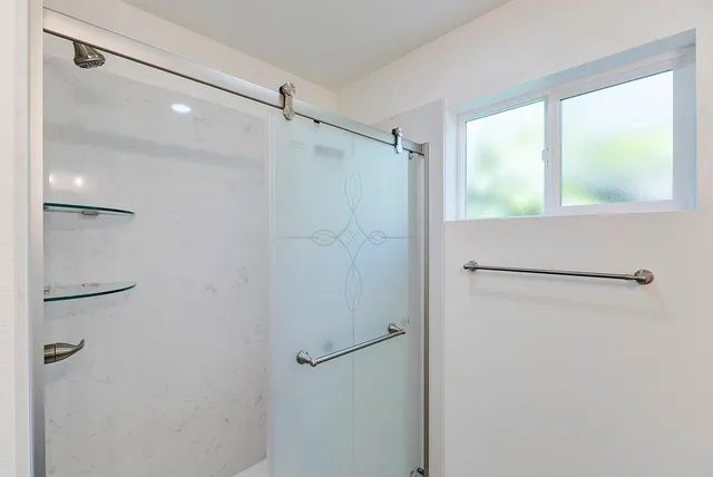 a bathroom with a glass shower door