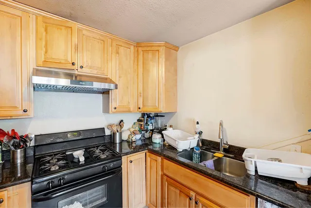 a kitchen with sink cabinets and appliances