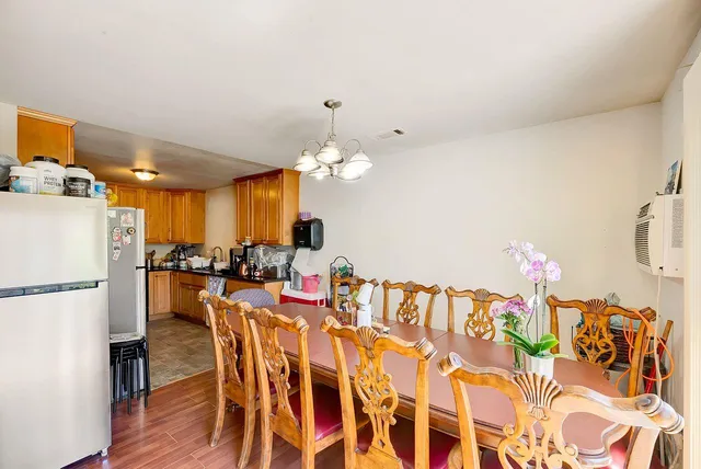 a kitchen with a dining table chairs and white cabinets