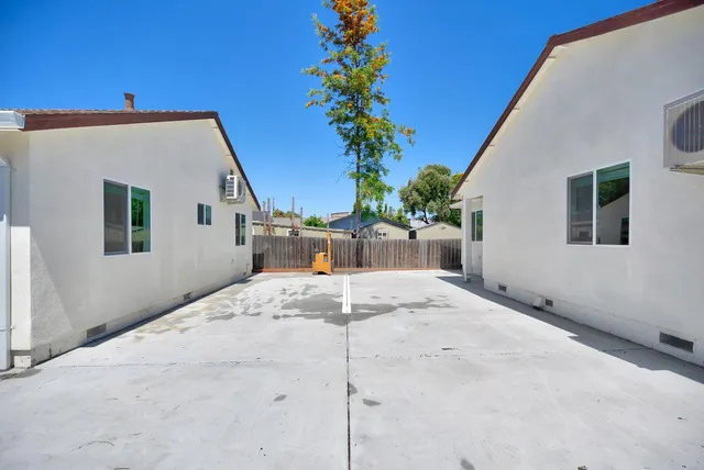 a backyard of a house with potted plants