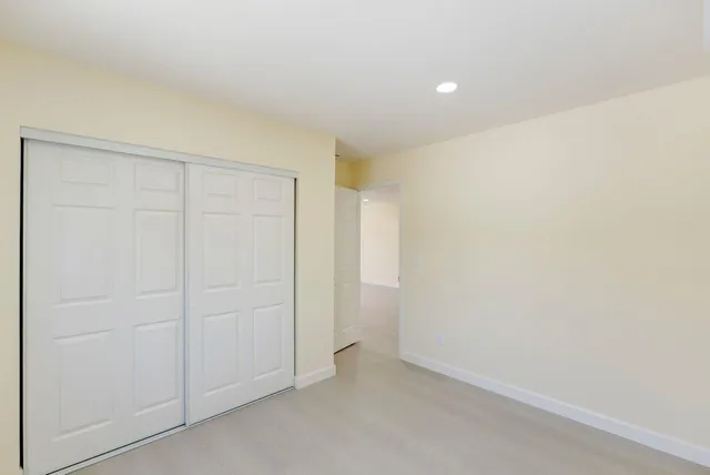 an empty room with closet area