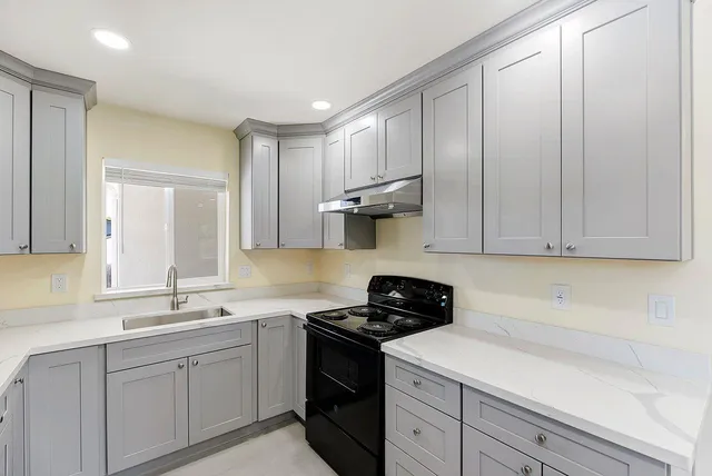 a kitchen with a sink and cabinets