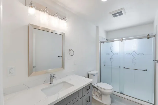 a bathroom with a sink toilet and shower