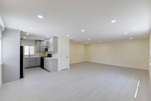 a view of kitchen with refrigerator sink and stove