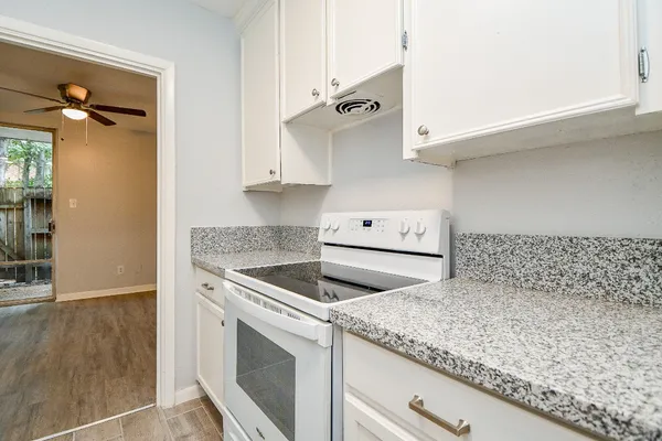 a kitchen with granite countertop a sink and a stove