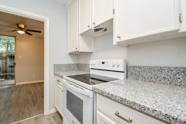 an empty room with wooden floor and cabinet