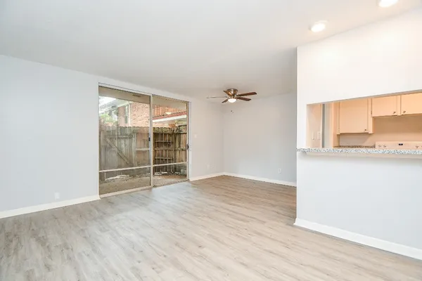 an empty room with wooden floor and cabinet