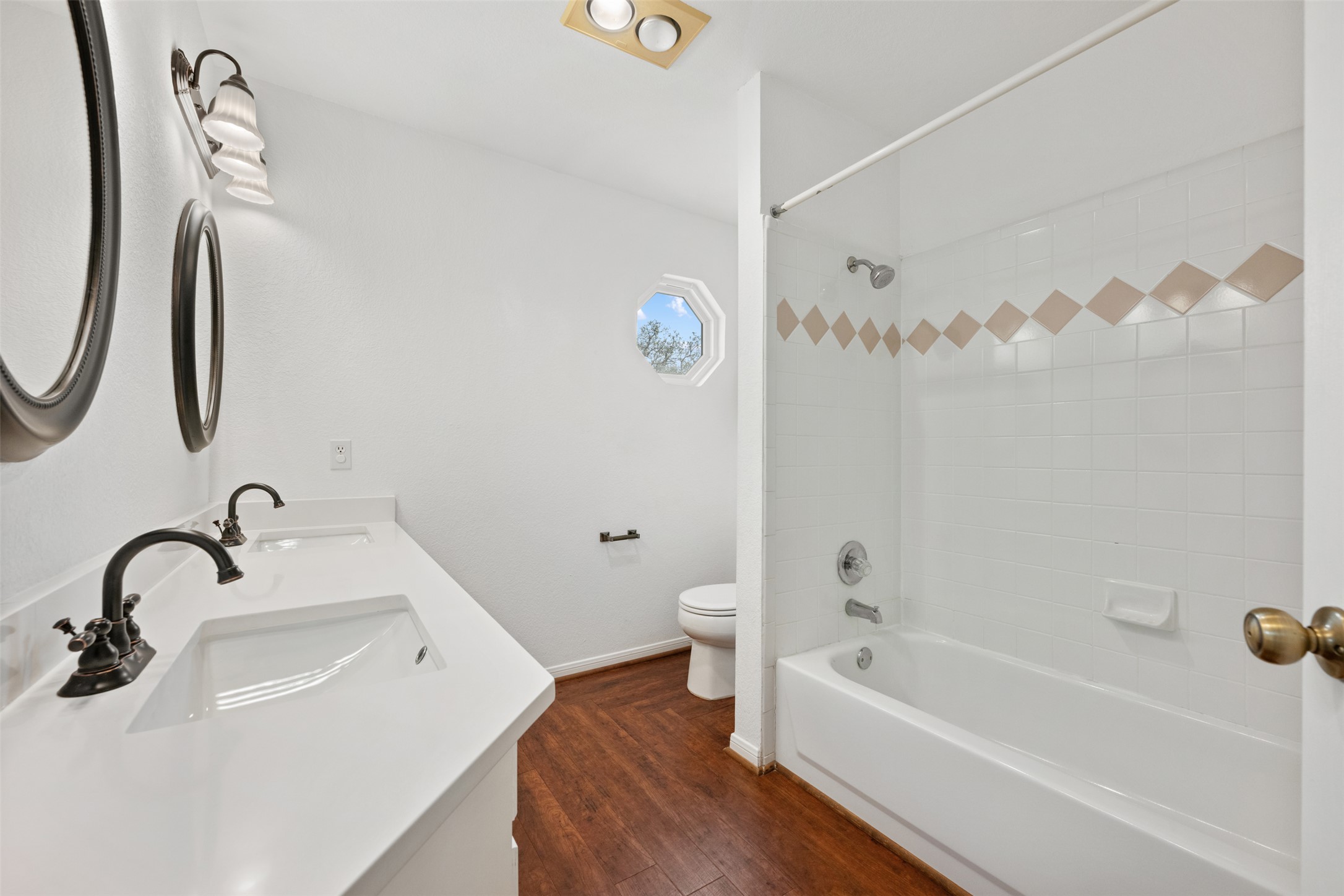 104 Sunset Road Georgetown, TX 78633 - Photo 33 of 40 Full bathroom featuring double vanity, dark wood finished floors, and shower combination