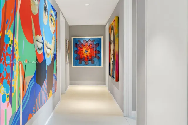 a view of a hallway with painting on the wall