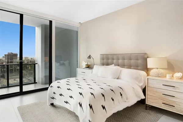 a bedroom with a bed and lamp with window