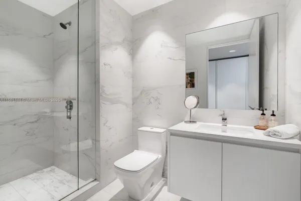 a bathroom with a toilet sink and shower
