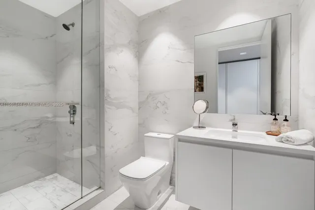 a bathroom with a toilet sink and shower