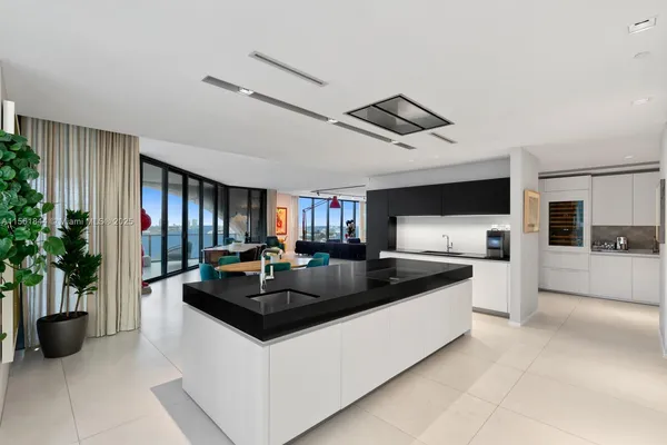a kitchen with granite countertop a sink and a stove top oven