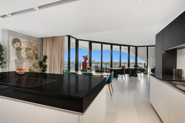 a living room with furniture and floor to ceiling window