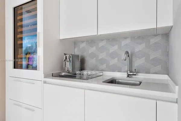 a kitchen with a sink and cabinets