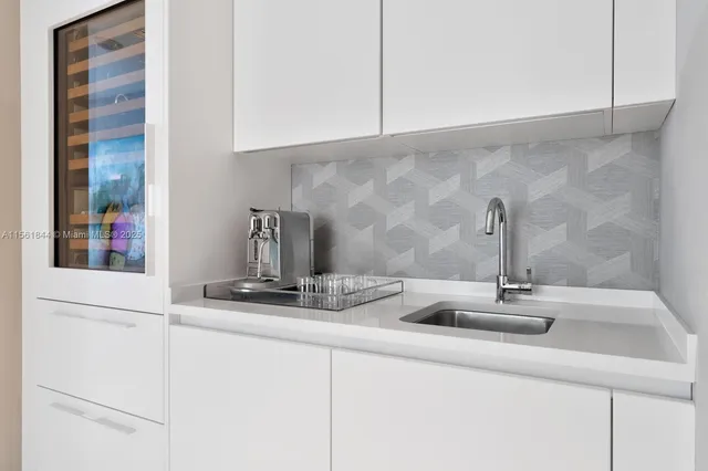 a kitchen with a sink and cabinets