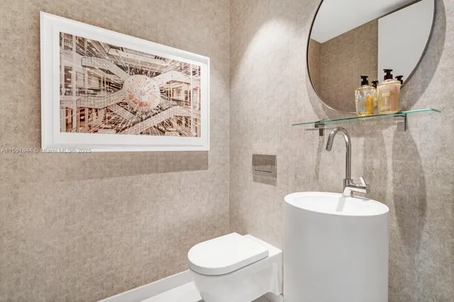a bathroom with a toilet a sink and mirror