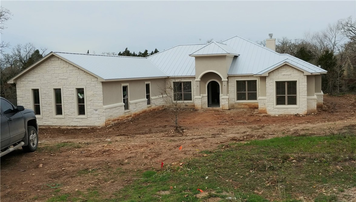 105 Old Windmill Road Bastrop, TX 78602 - Photo 1 of 1 105 Old Windmill Ln, Bastrop, The Colony, Front elevation, 3 car garage with side entrance, Metal roof. Construction scheduled to be complete April 2020