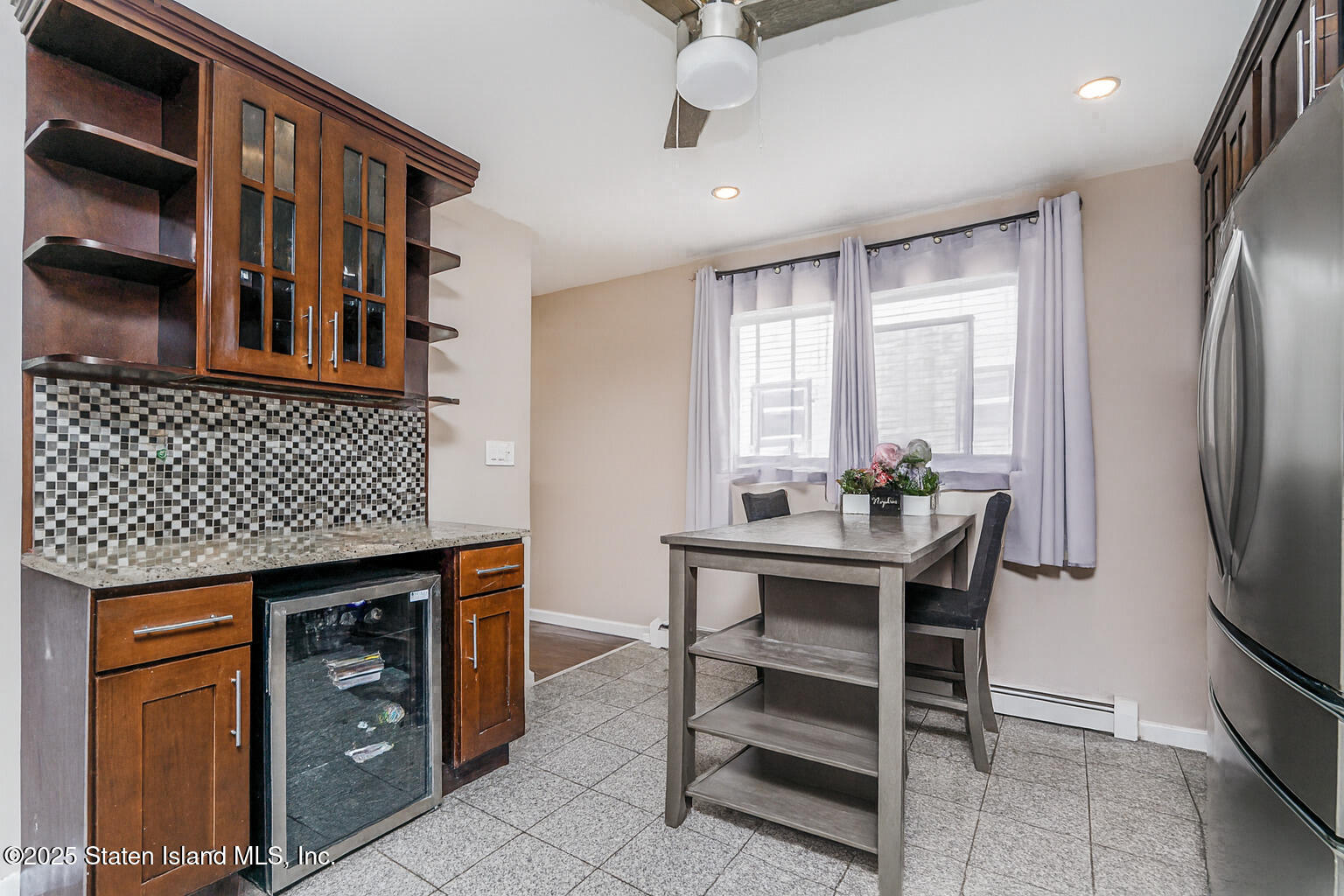 191 Lamberts Lane Staten Island, NY 10314 - Photo 11 of 32 a kitchen with stainless steel appliances kitchen island granite countertop a table chairs in it and a window