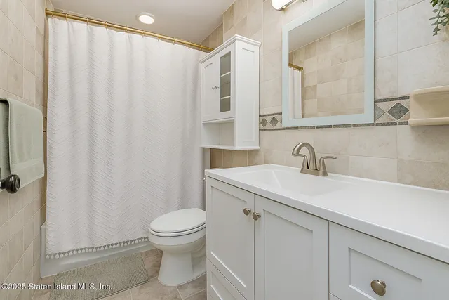 a bathroom with a toilet sink and shower