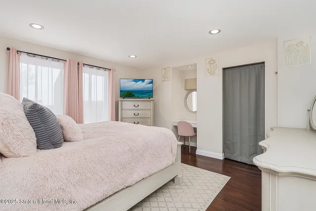 a bedroom with a bed and a book shelf
