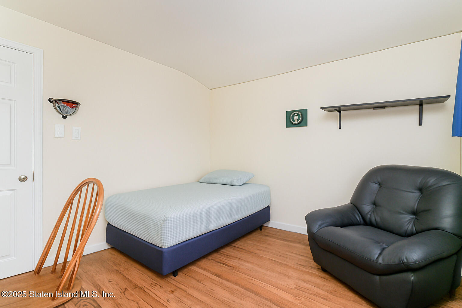 191 Lamberts Lane Staten Island, NY 10314 - Photo 19 of 32 a bedroom with a bed and a chair