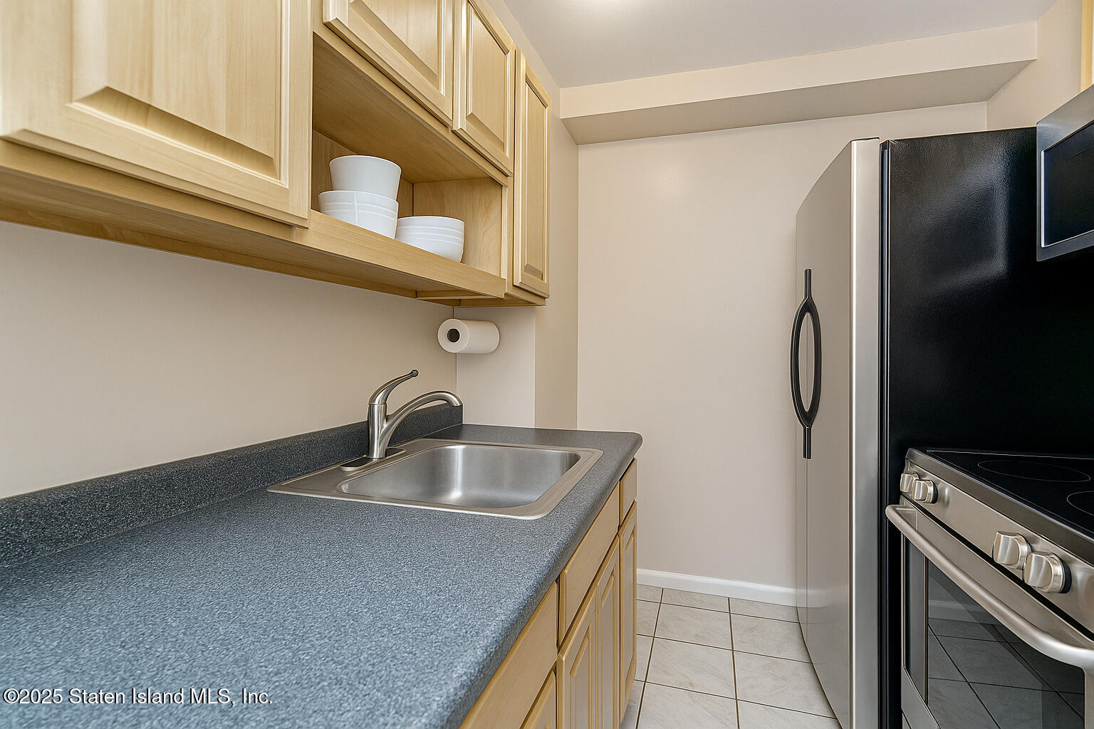 191 Lamberts Lane Staten Island, NY 10314 - Photo 29 of 32 a kitchen with stainless steel appliances granite countertop a sink and a refrigerator