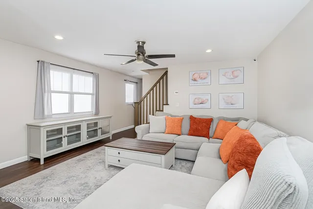 a kitchen with stainless steel appliances kitchen island granite countertop a table chairs in it and a window