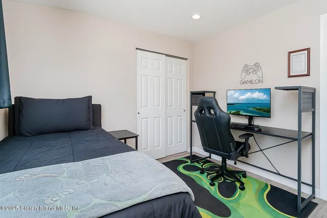 a bedroom with a bed and a flat screen tv